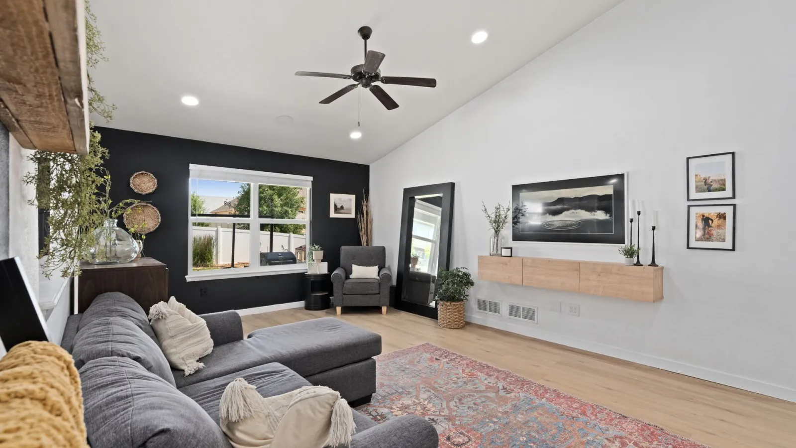 Modern yenilenmiş oturma odası, gri koltuk, ahşap zemin ve duvar dekorasyonu